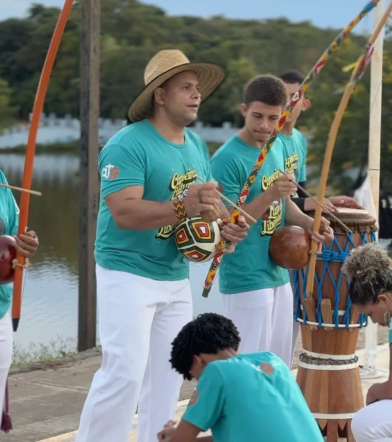 Participantes do CRESCER com instrumentos de capoeira.